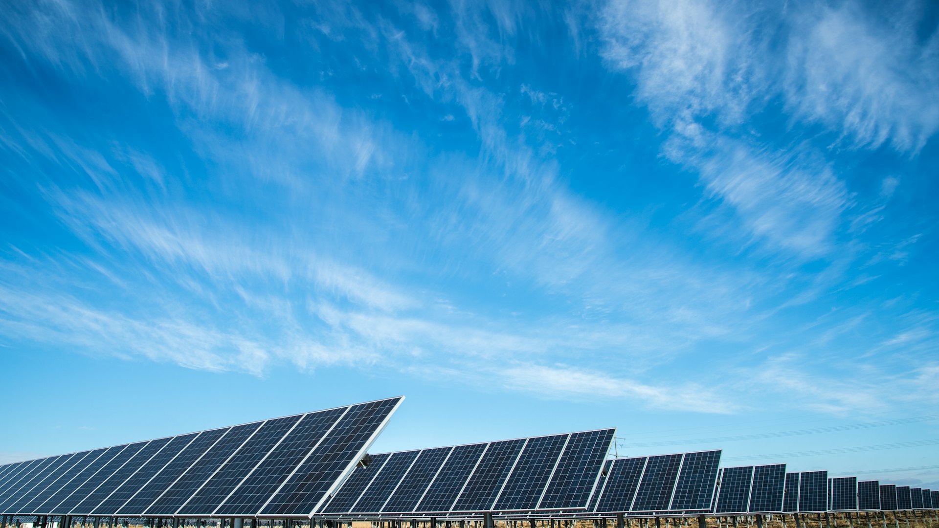 Solar panels under a bright blue sky